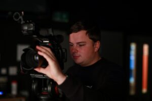 A Digital Media Producer using a camera.