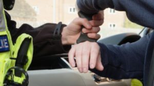 A person being handcuffed.