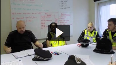 A screenshot of police officers in a briefing. Click to view video on Panopto.