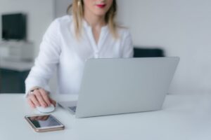 A woman using a laptop.