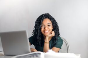 A smiling person using a laptop